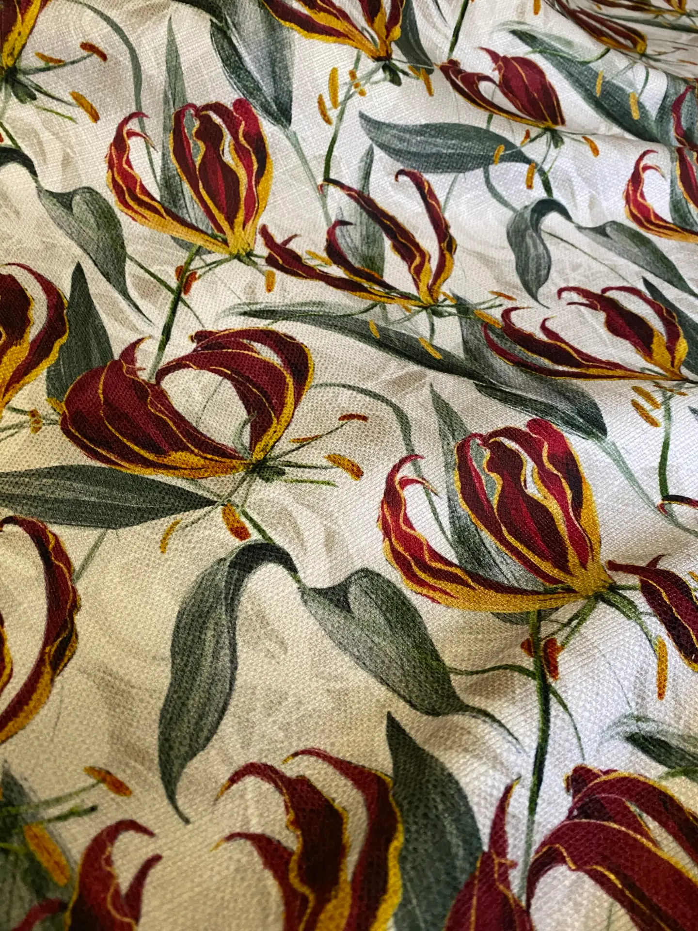 Photograph of a printed fabric showing the flame lily pattern drawn by Phillippa Jane.